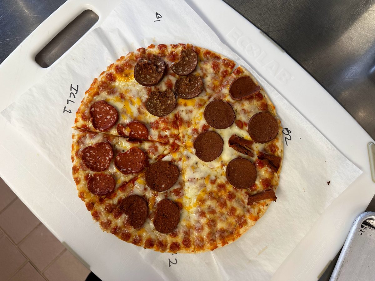 A test pizza split into labelled sections, each topped with a different pepperoni variant